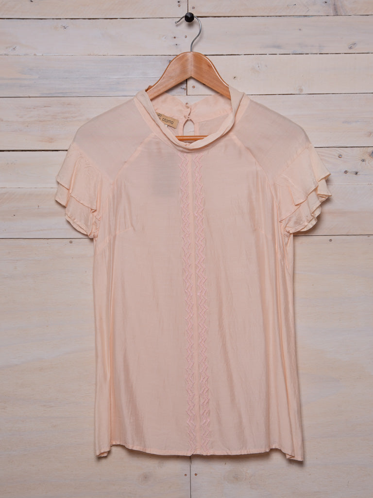Embroidered top with ruffled sleeves Colour: Shell pink silk linen blend with soft pink embroidery zig zags down the front seam.