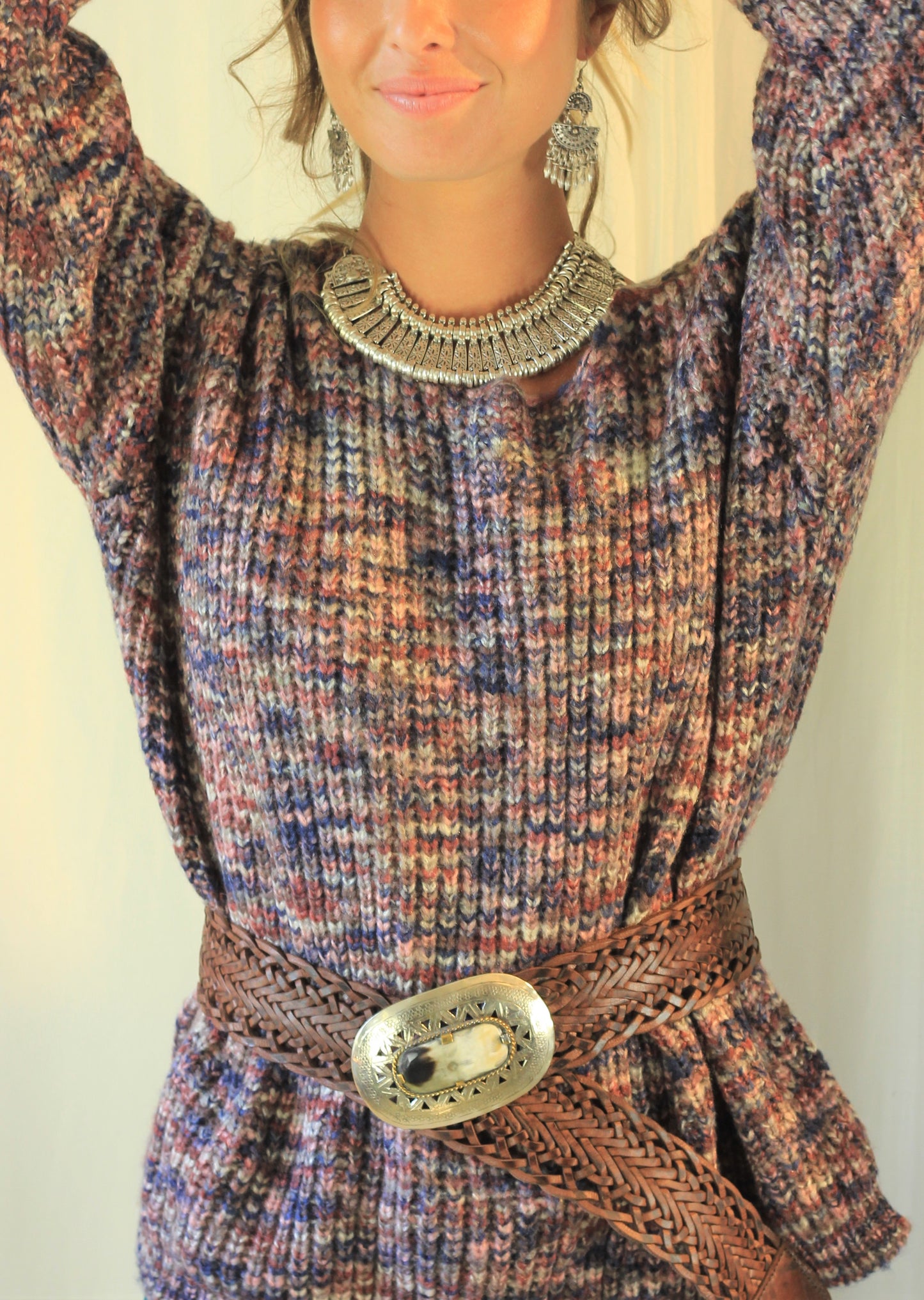 Lady wearing selene necklace with belt and jumper