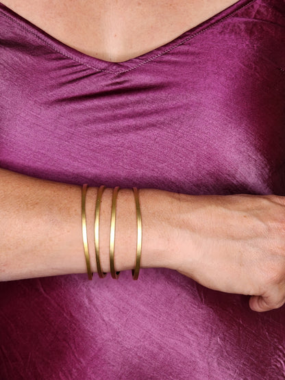 model wearing sexy silk slip and gold bangles