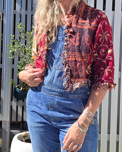 woman in denim overals and wine coloured silk jacket