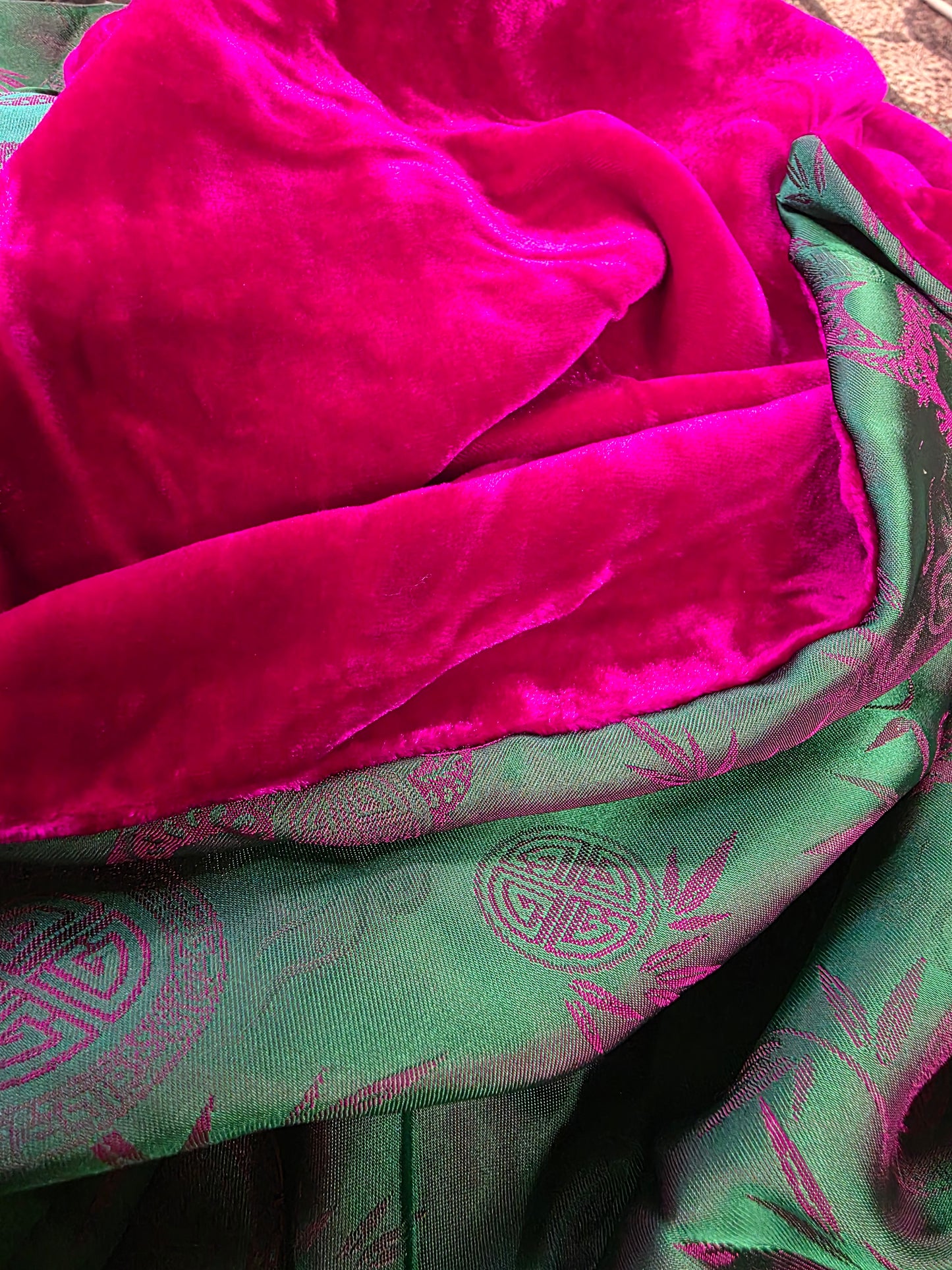 Close-up of pink and green fabric with intricate patterns