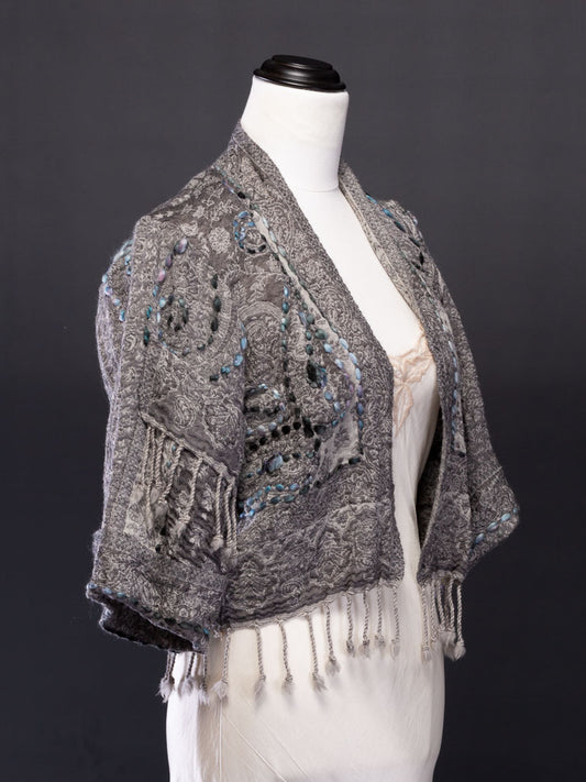 A soft grey coloured wool kashmiri jacket with fringing in boho style