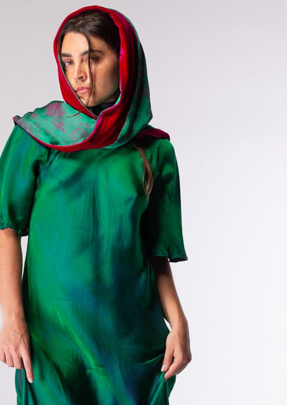 Woman wearing scarf as head dress in magenta and green 
