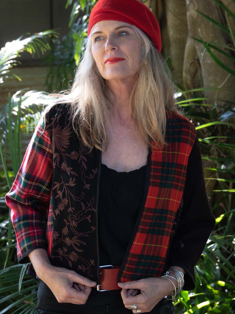 Woman wearing tartan and hand embroidered wool jacket