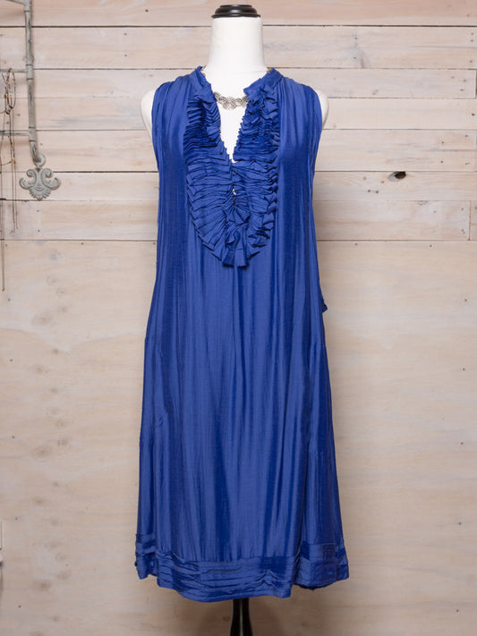 This sleeveless dress features a raw edged ruffled neck, the outer layer with pockets in a light natural fabric.  Colour: Royal Blue