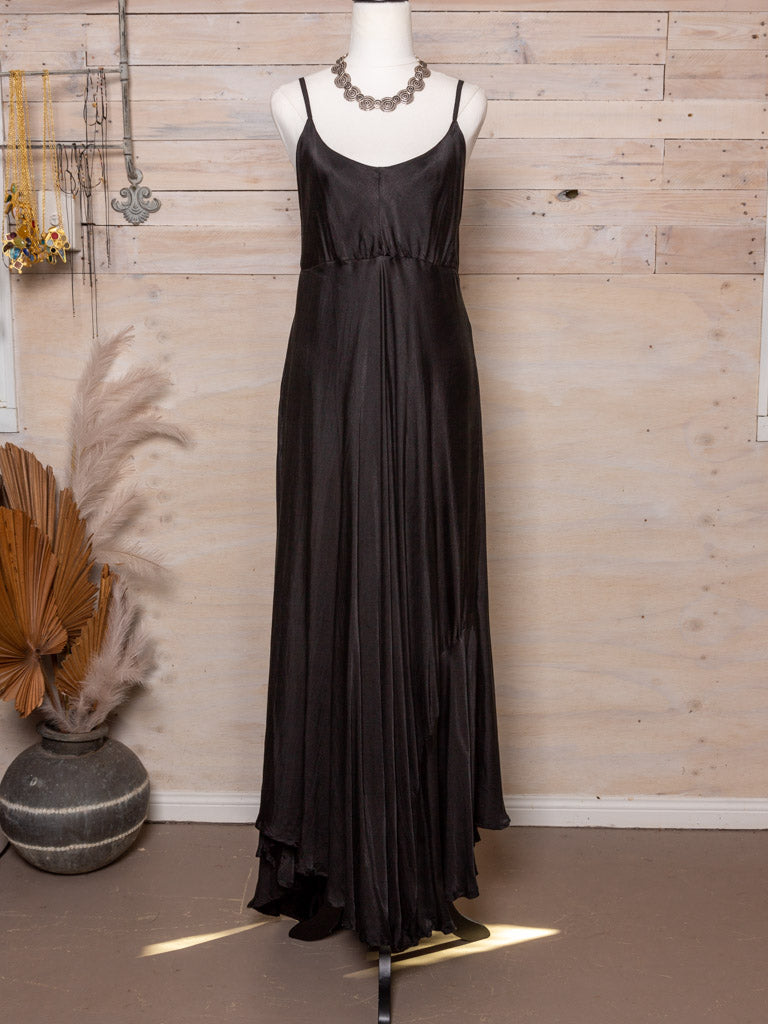 This dress features thin adjustable straps,  an empire line waist and longer train at the back in light natural material cut on the bias.  Colour: Black