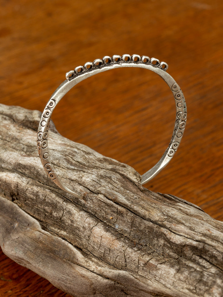 twisted silver cuff with circular patterns