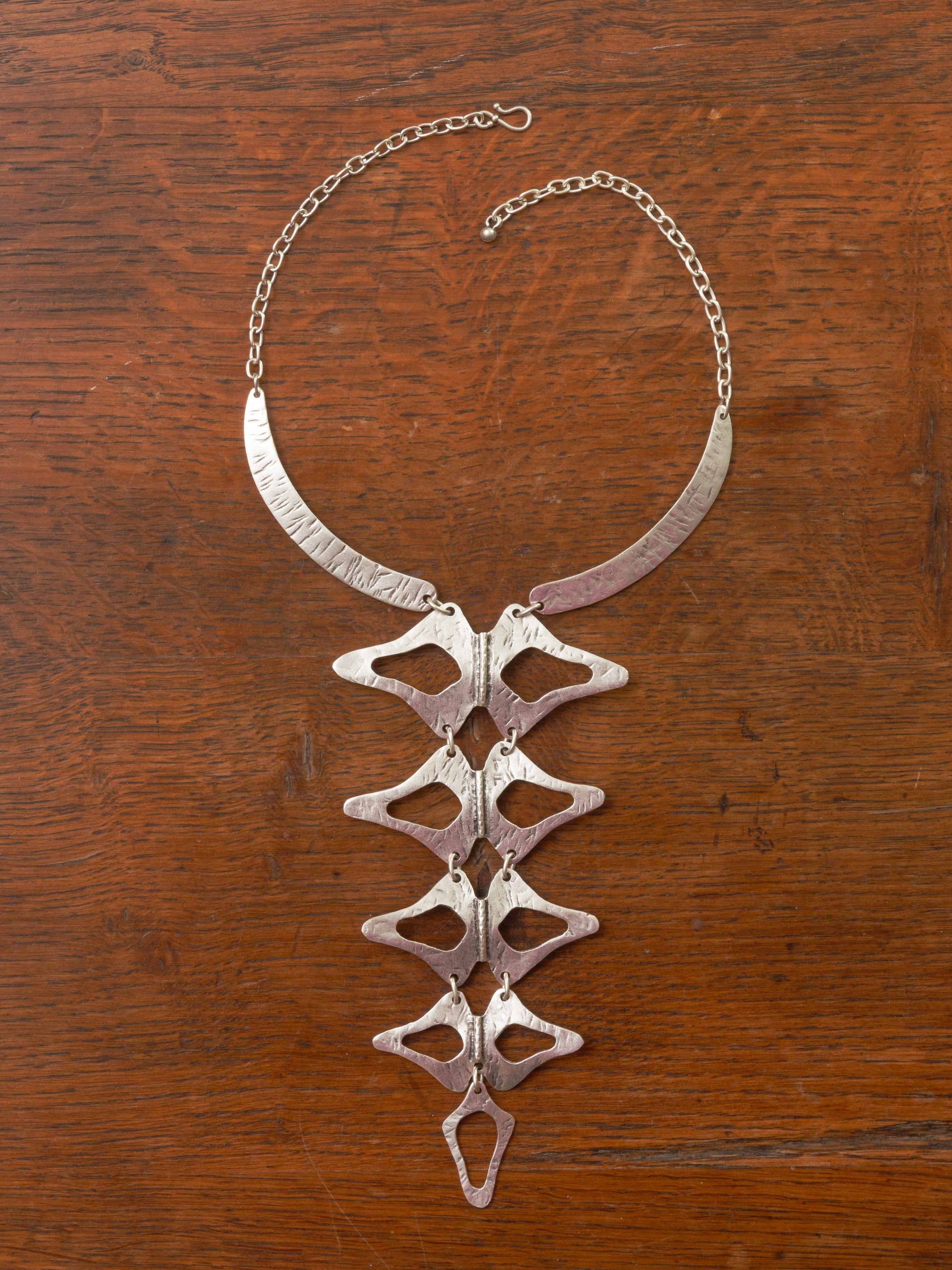 silver necklace with a skeletal design