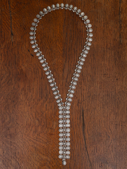 Silver necklace with beads on a wooden surface