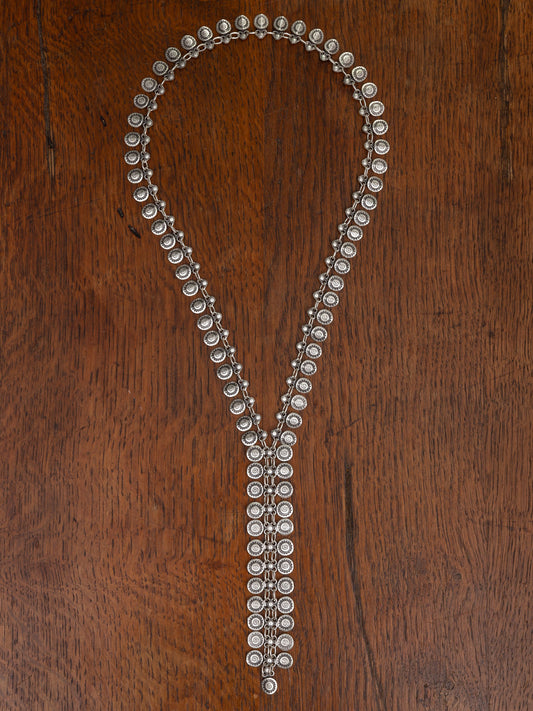 Silver necklace with beads on a wooden surface