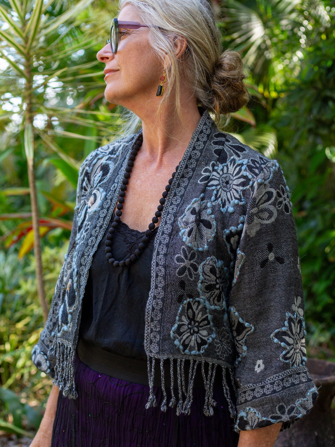 Grey - black wool fringed jacket with flower design and embroidery in jungle setting