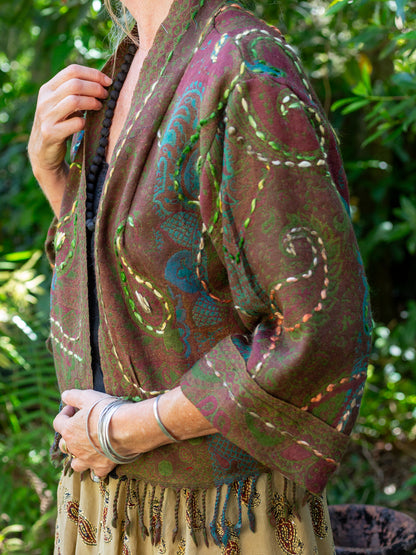 Person wearing a patterned jacket with a natural background