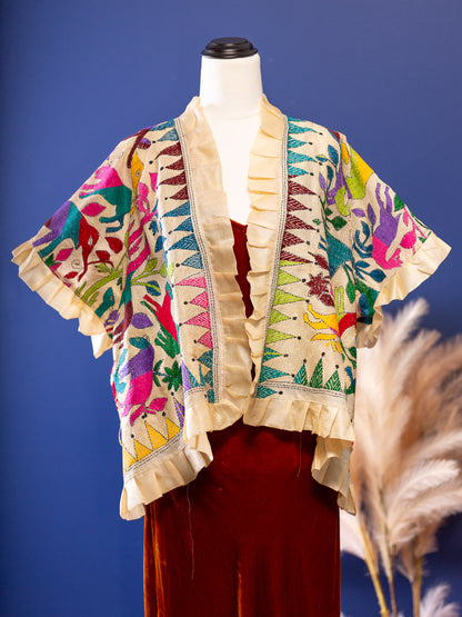 Hand embroidered silk jacket with animal theme in vivid colours on a cream backdrop