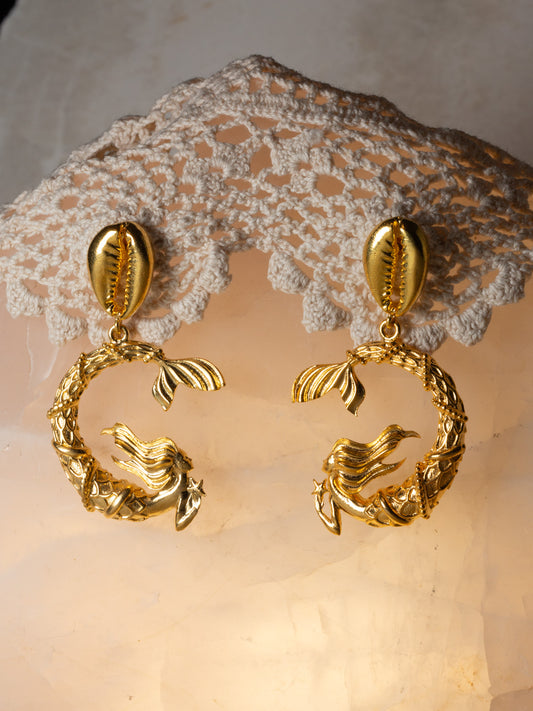 Gold mermaid earrings off a cowrie shell stud