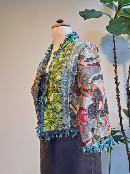 Mannequin wearing a colorful patterned jacket with a plain background