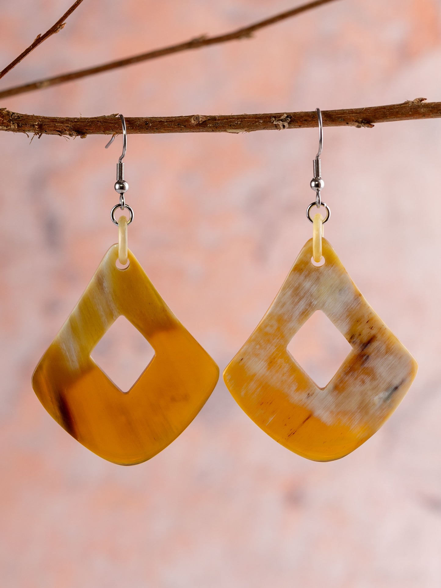 Natural bone earring shapes as a rounded diamond