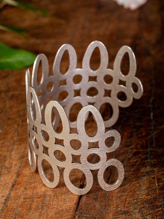 wide silver cuff with circular cut out pattern
