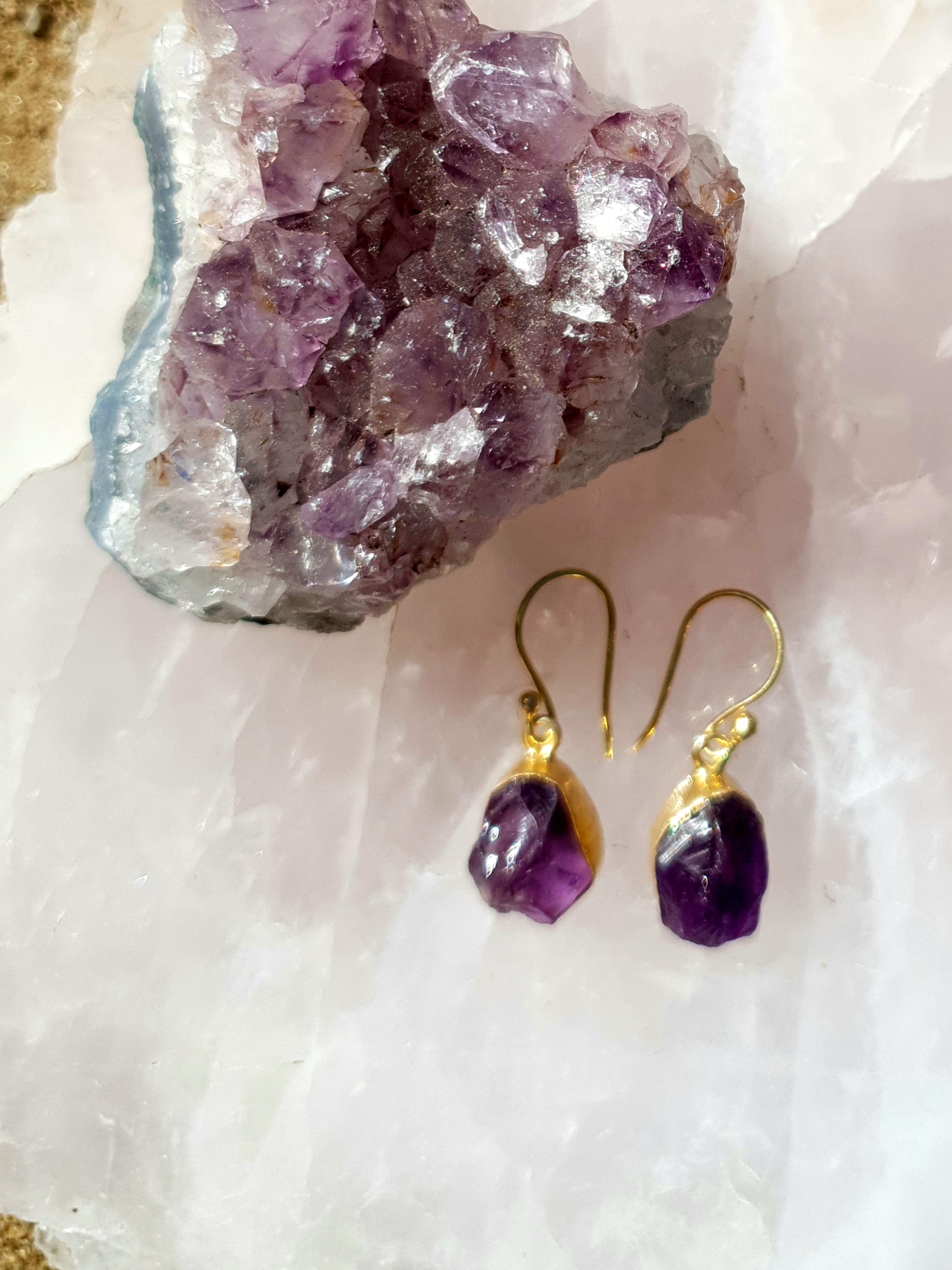 Amethyst rock with a pair of gold amethyst raw cut earrings