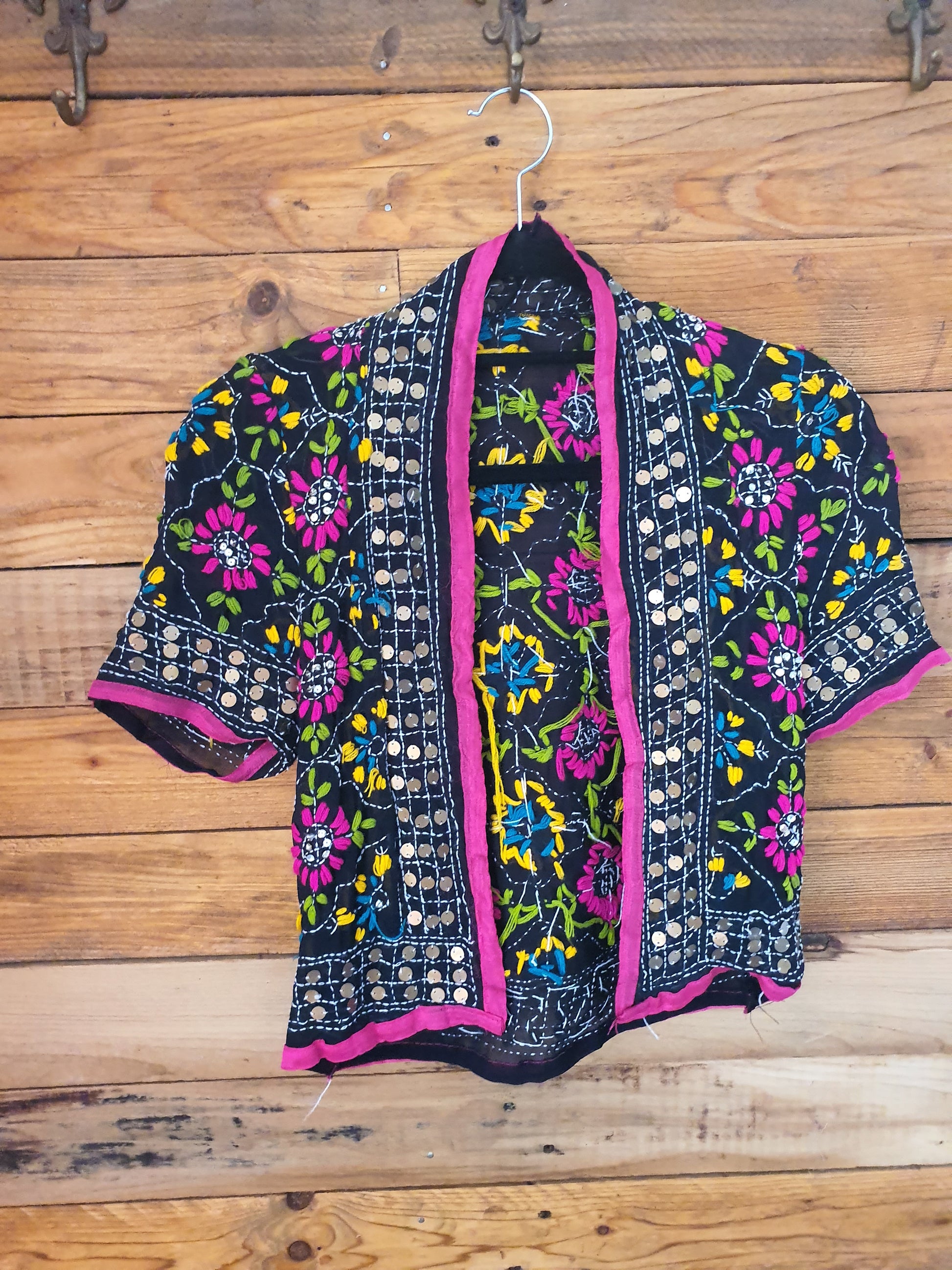 Front view of capped bolero with embroidery