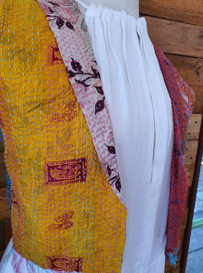 Side view of hand stitched vest with yellow design