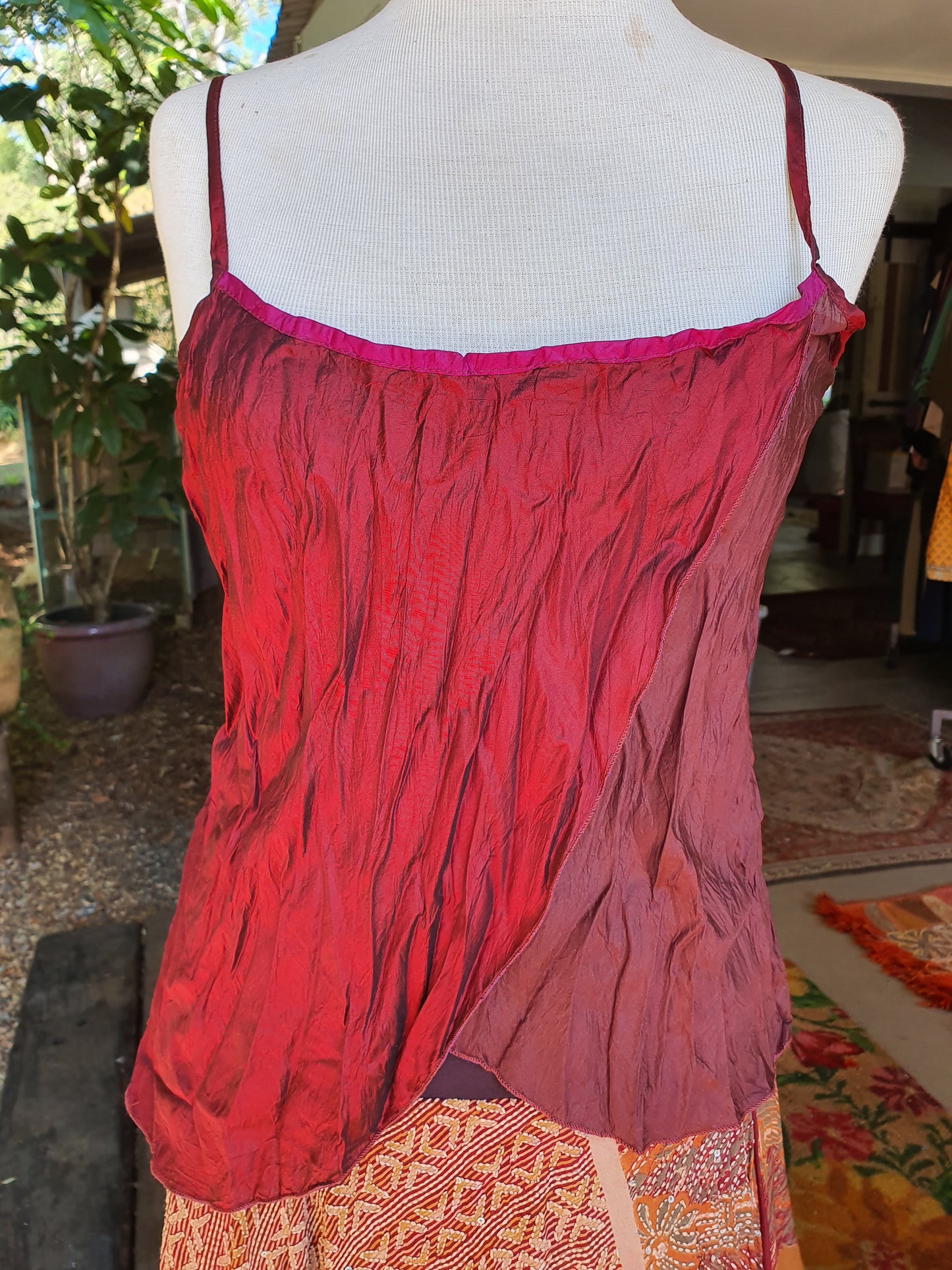 Picture of a silk slip in 3 colour shades of maroon