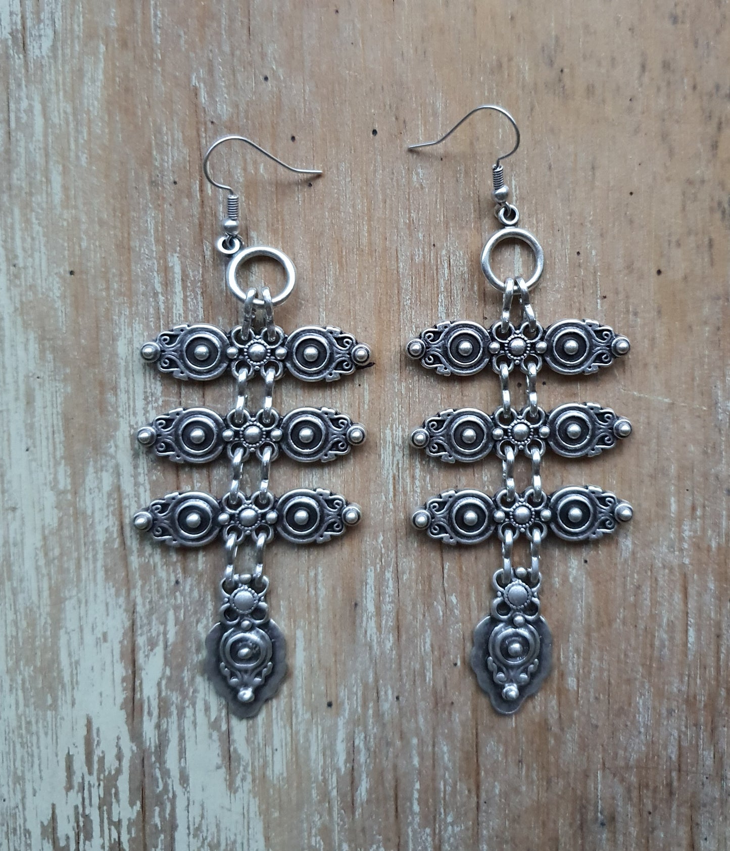 Silver crest dangle earrings