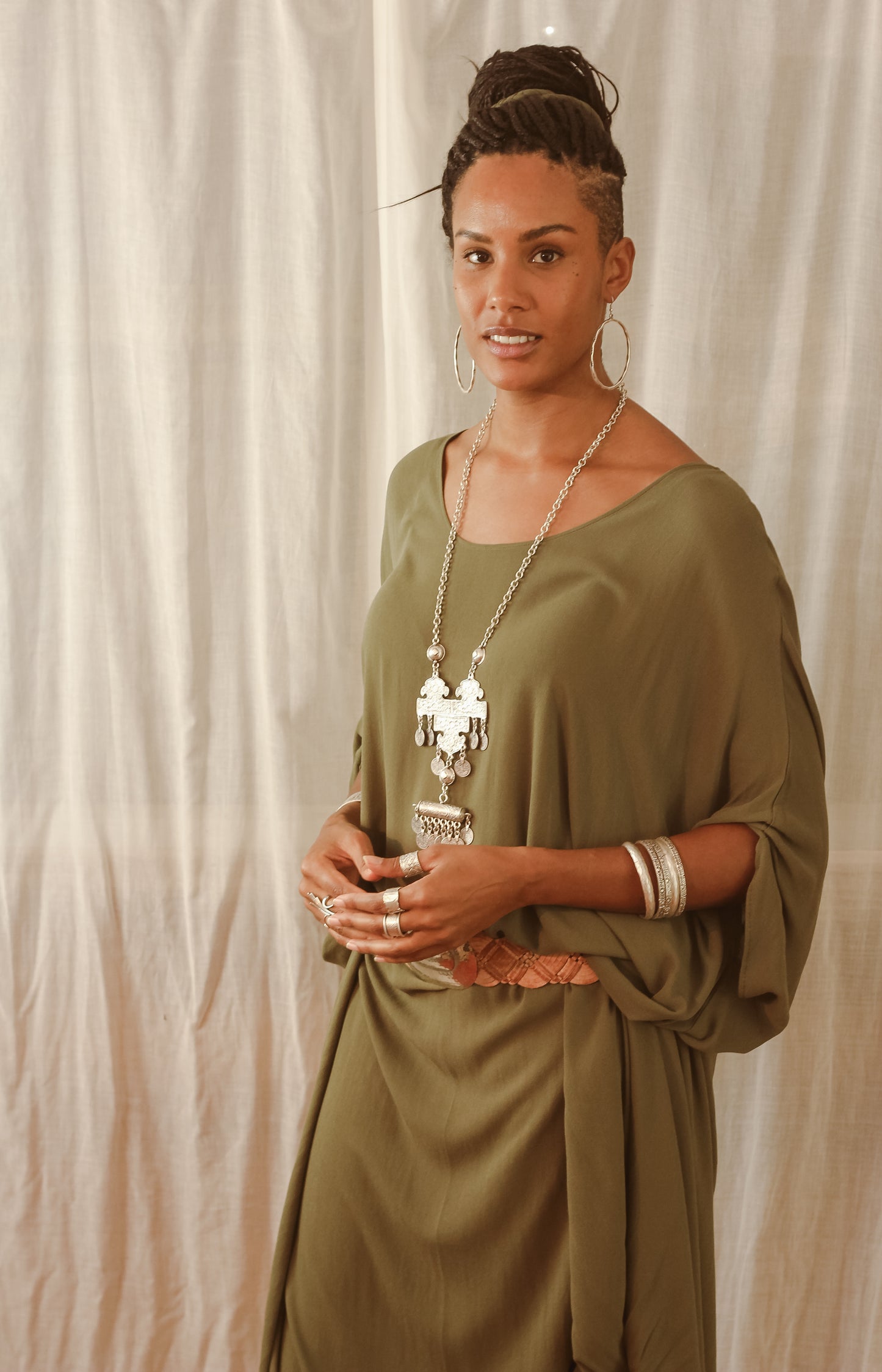 A lady wearing a green kaftan with silver jewellery