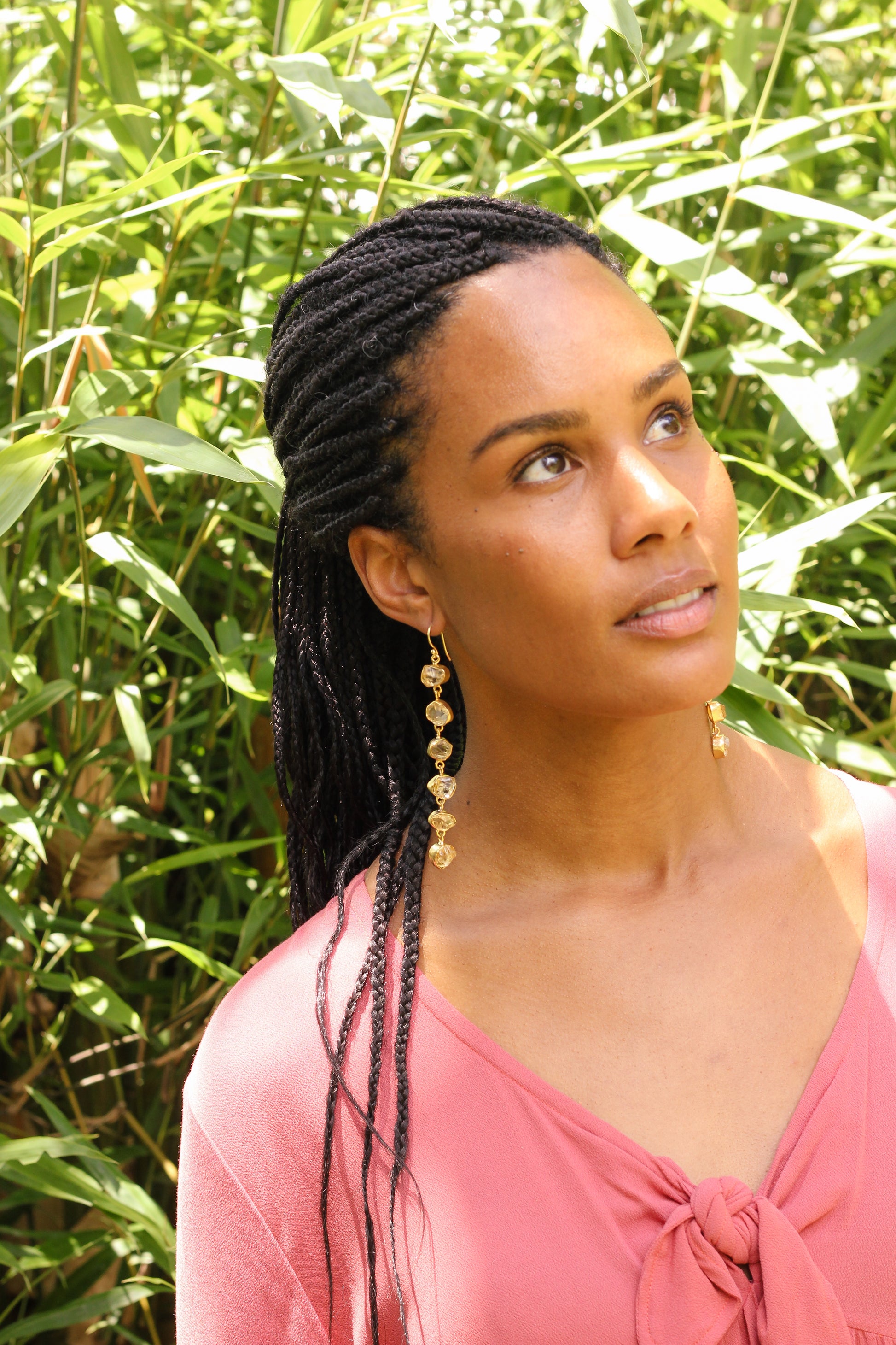 A lady with 6 stone drop gold earrings in citrine