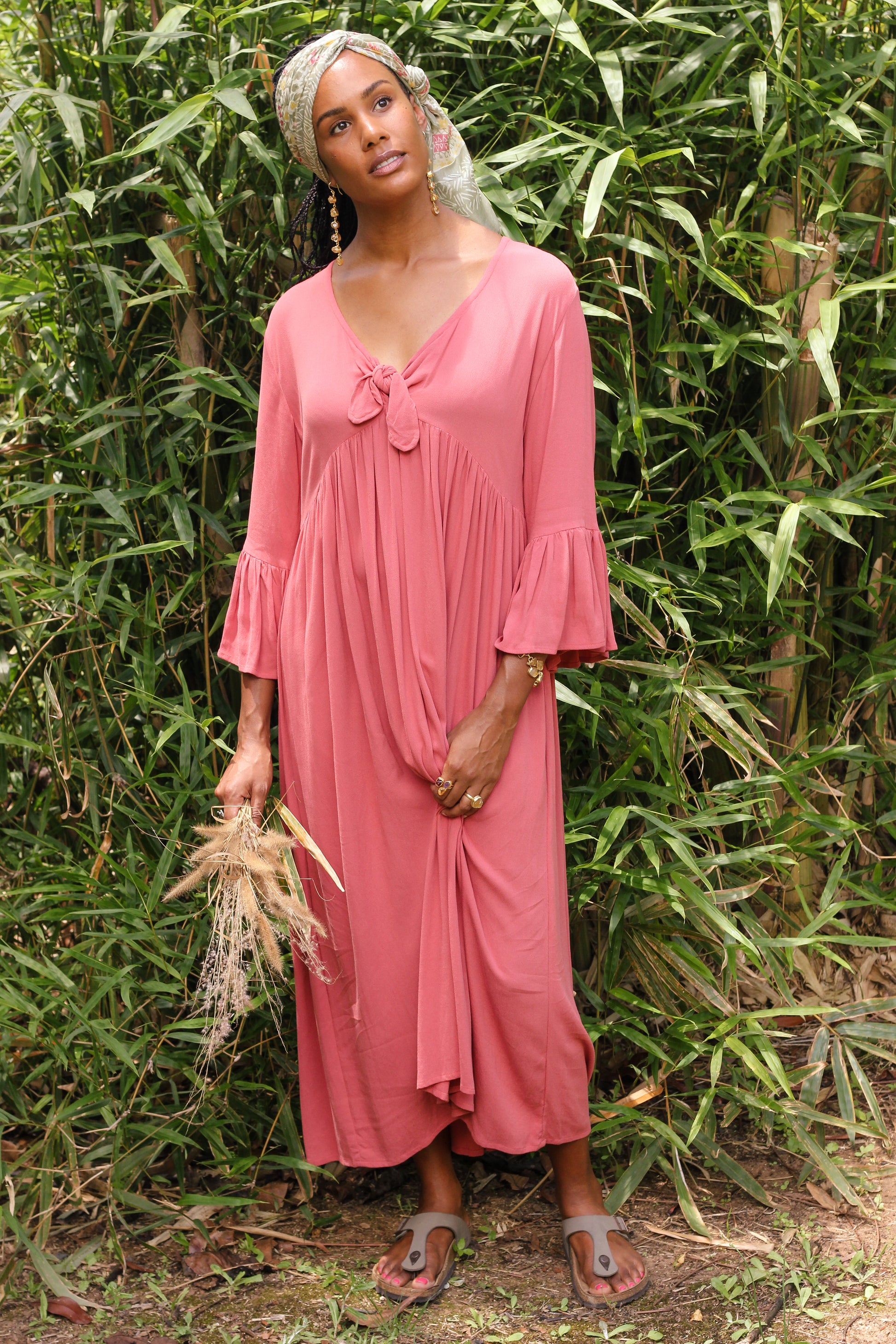 Lady in a peach dress with scarf and aqua marine 6 drop gem earrings