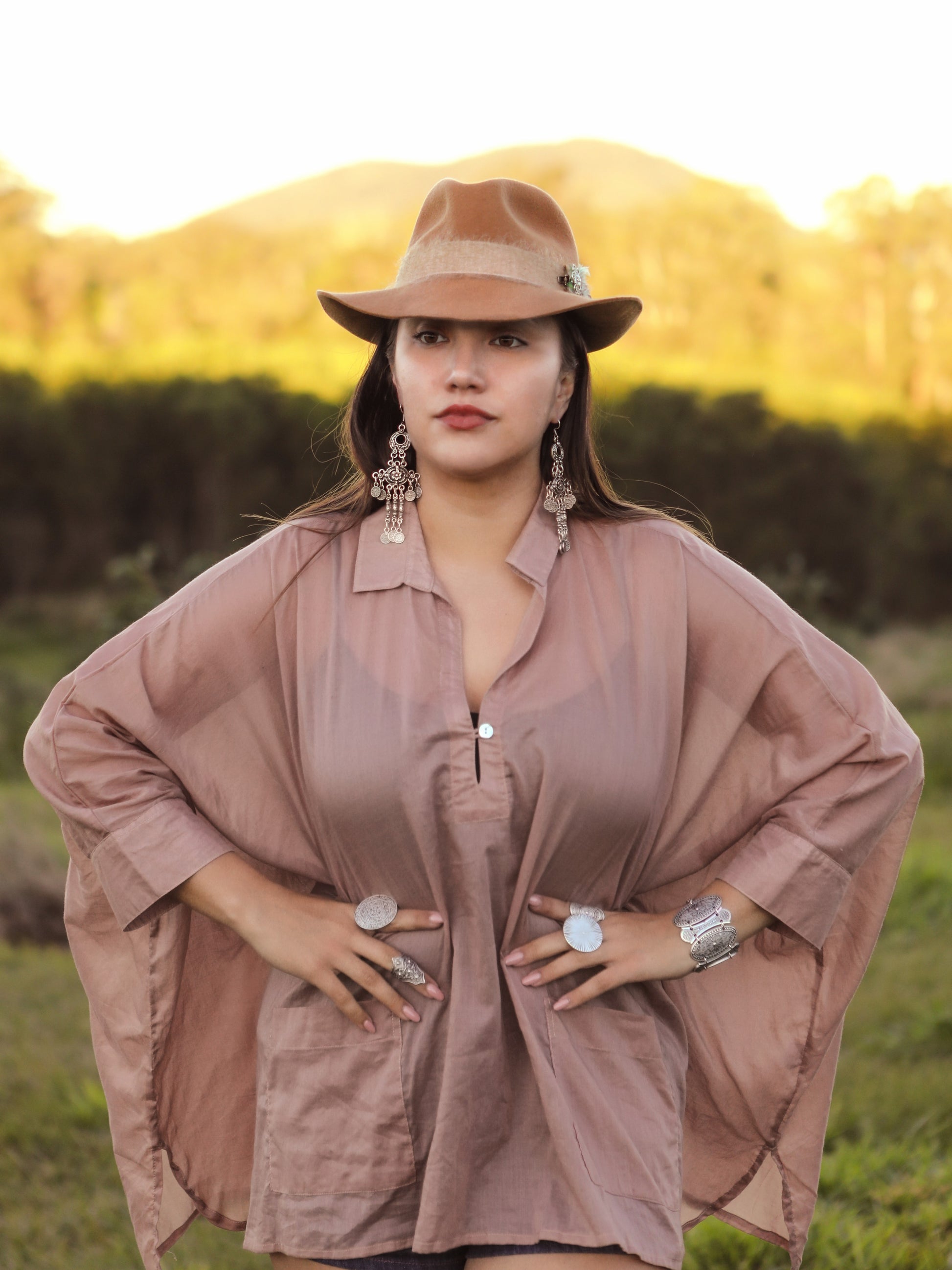 Woman wearing boho outfit with long silver earrings