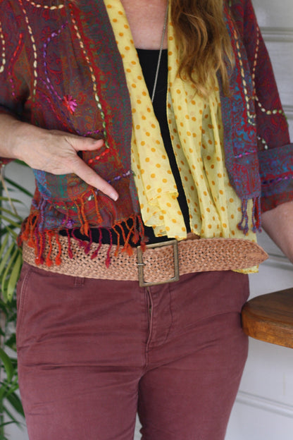 Woman wearing a wide leather belt with brass buckle
