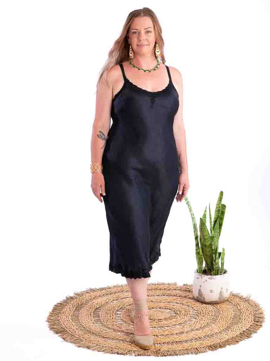 curvy woman wearing dark indigo silk slip dress