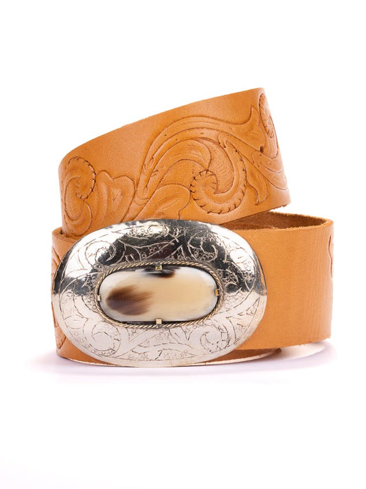 A hand tooled leather belt with wide scroll design and bone buckle