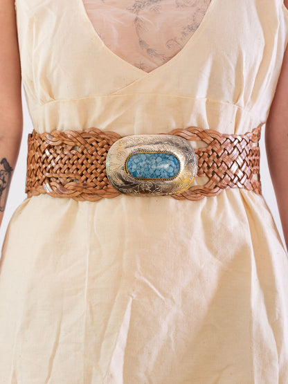 Tan coloured wide woven leather belt with an oval buckle.