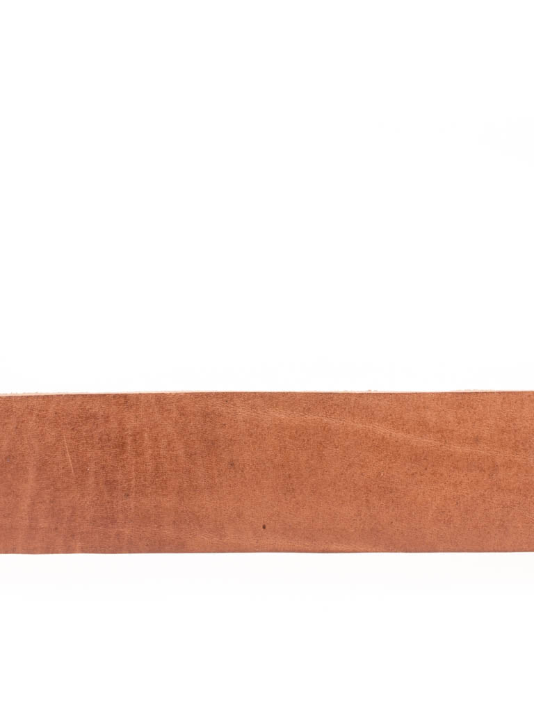 Close up of tan leather belt.