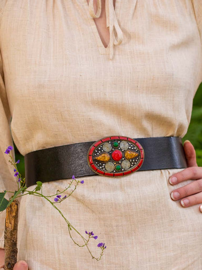 Black leather belt with red intricate detailed buckle