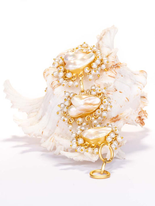 pearl linked bracelet , gold luxeBaroque pearls, surrounded by clusters of beads forming a linked bracelet in a quality gold plated brass, styled with a T-bar catch.