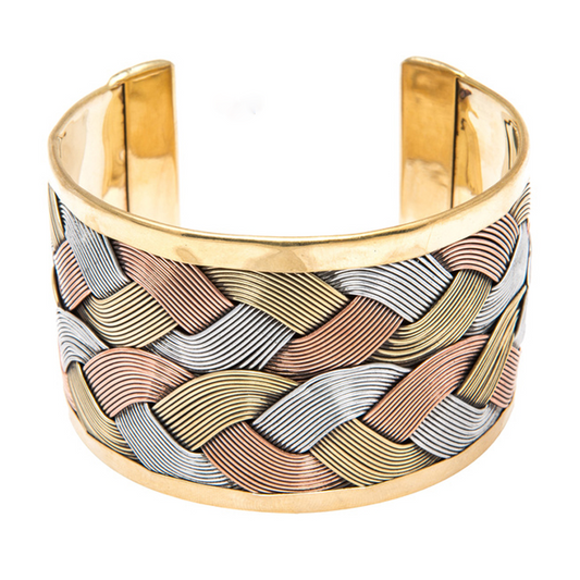 A wide woven cuff with wave design in copper silver and brass