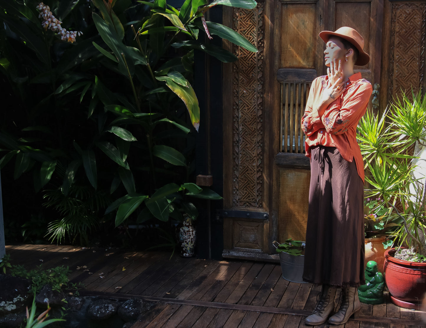 Woman in boho setting wearing a chocolate silk linen skirt