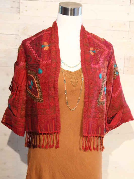 This jacket with shades of red with pops of turquoise and orange accents