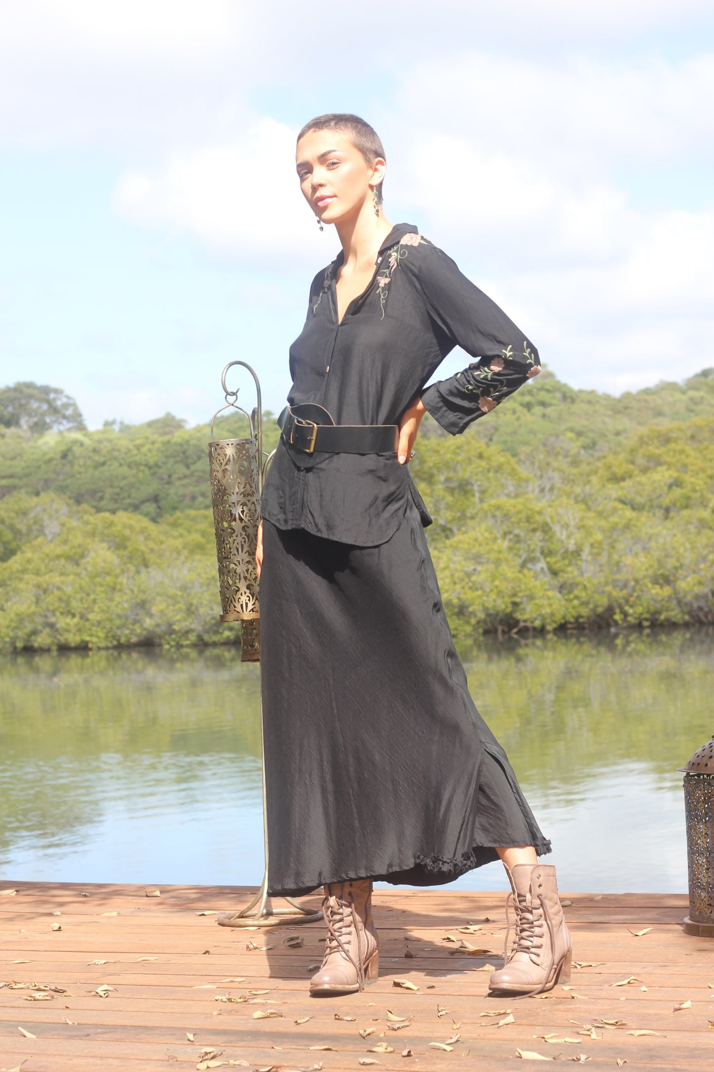 Woman wearing black silk top and skirt