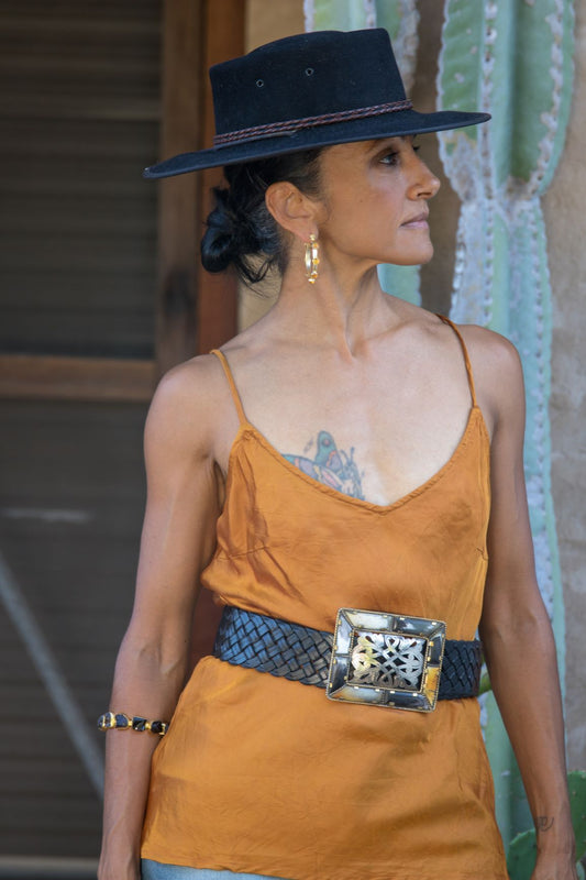 Gold satin cami, wide leather belt on model