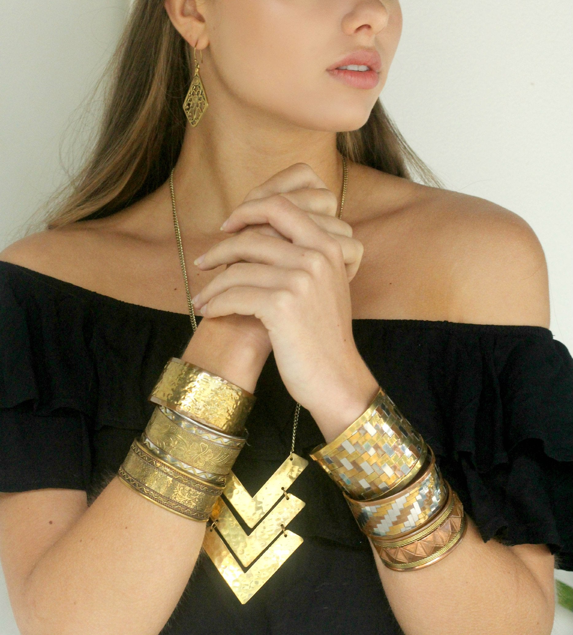 A lady wearing a stack of cuffs together