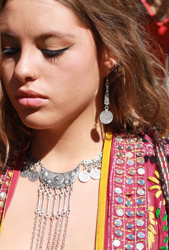 Woman wearing tribal coin earring and necklace
