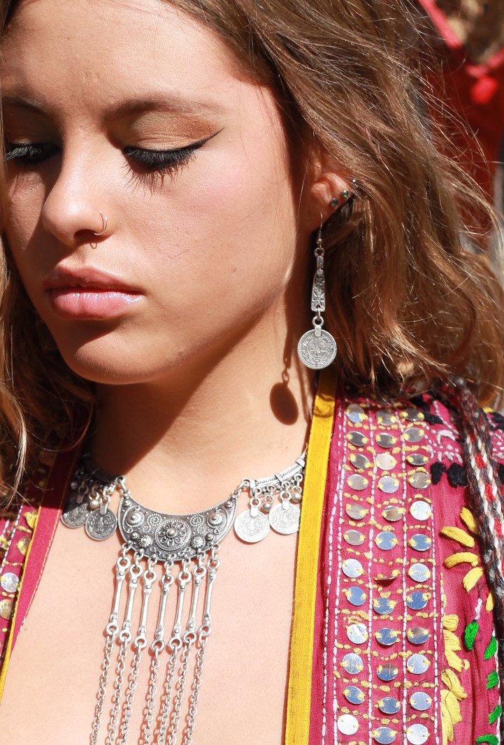 Woman wearing tribal coin earring and necklace