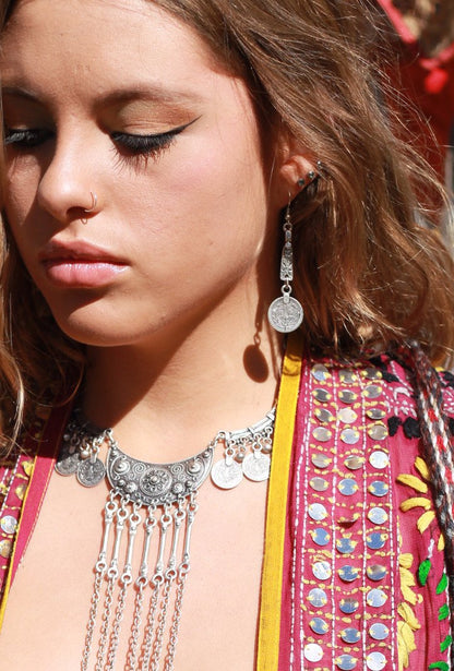 Woman wearing tribal coin earring and necklace