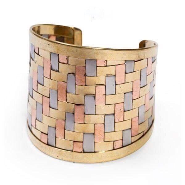 A wide woven cuff with silver brass and copper