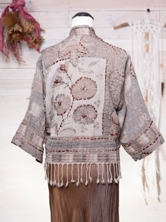 A soft taupe brown coloured wool jacket with flower design and fringing