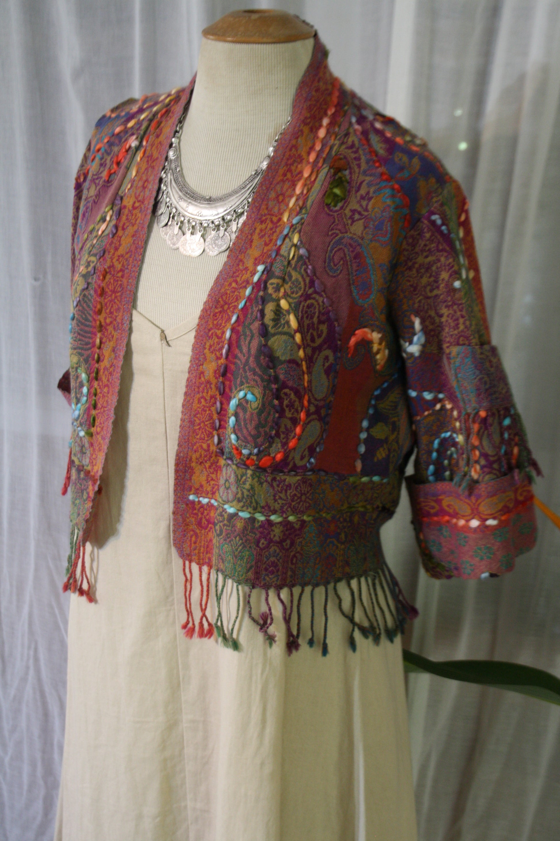 Mannequin with fringed kashmiri jacket and silver challenger necklace