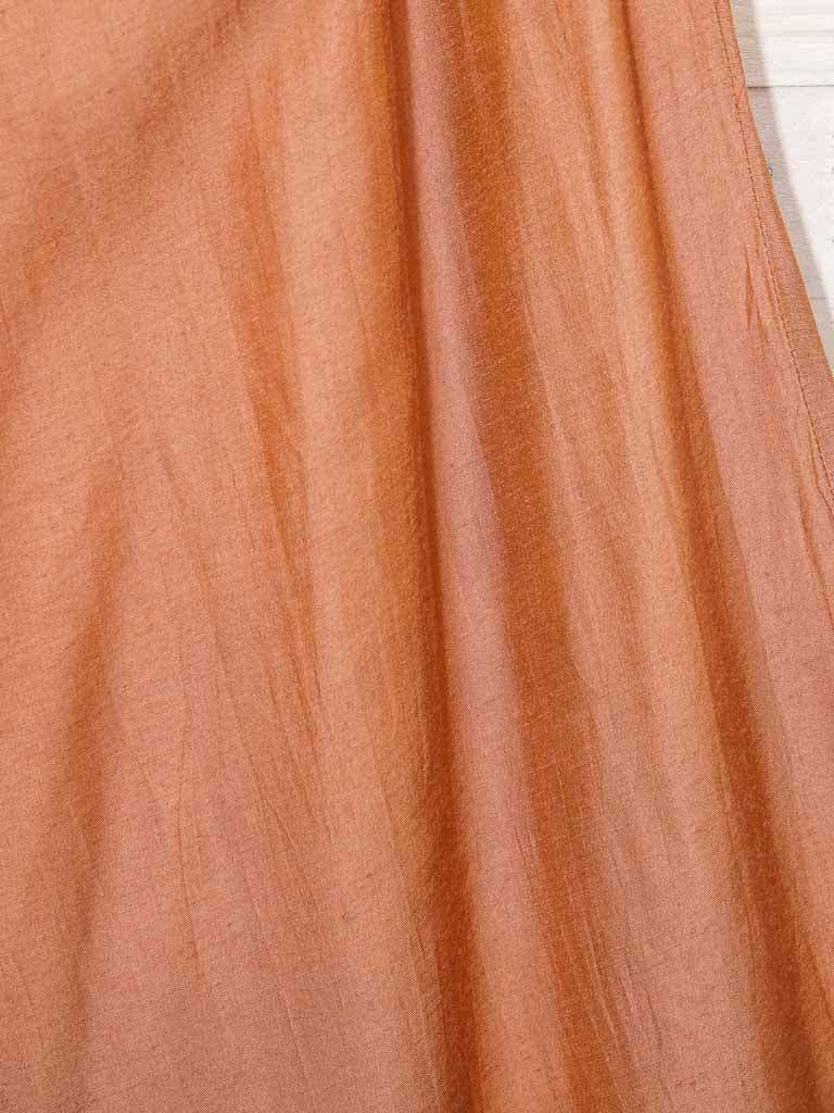 close up of silk and linen blend burnt orange colour